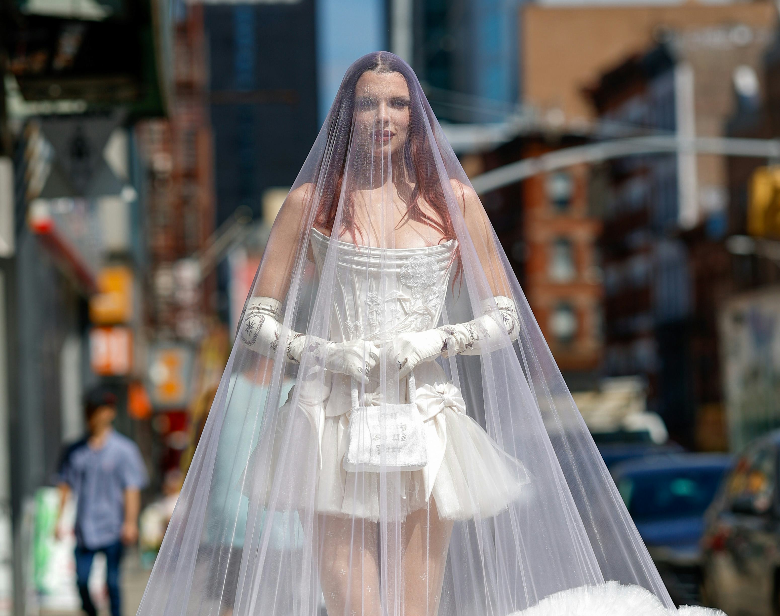 Julia Fox wears a wedding gown, veil, and gloves to Wiederhoeft&rsquo;s NYFW show.