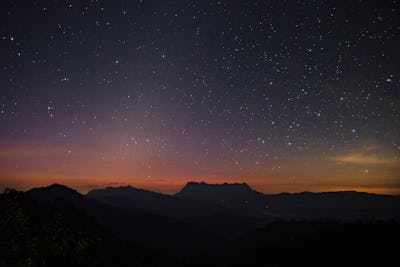 The starry night with zodiacal light over the peak of Mt. Doi Luang Chiang Dao before sunrise.