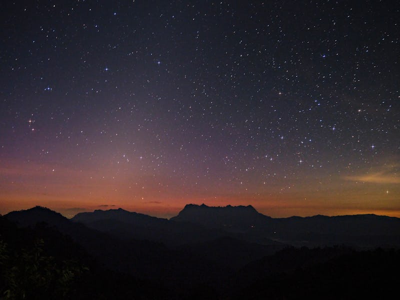 The starry night with zodiacal light over the peak of Mt. Doi Luang Chiang Dao before sunrise.