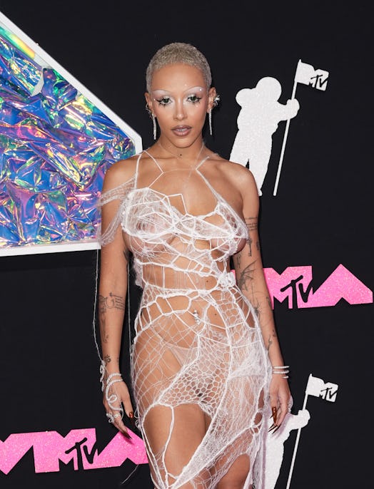 Doja Cat frees the nipple and exposes her thong in a gauzy mesh dress to attend the 2023 MTV Music V...