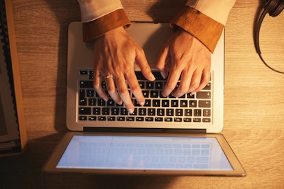 Hands, night and business person typing on a laptop for project with a deadline in home office worki...