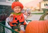 a baby in a costume in an article about can babies go trick or treating?