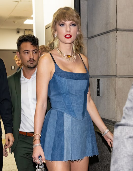 Taylor Swift wears a denim corset mini dress. 