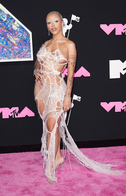 Doja Cat frees the nipple and exposes her thong in a gauzy mesh dress to attend the 2023 MTV Music V…