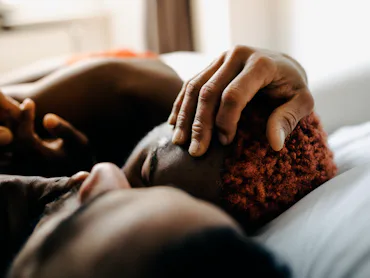 couple lying in bed after trying kinks based on their zodiac sign