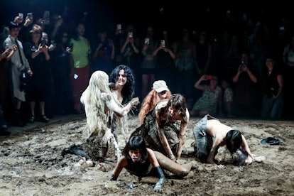 Models wrestle in the mud during the Elena Velez Ready to Wear Spring/Summer 2024 fashion show. 
