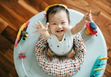 a baby girl having fun playing in activity centre. is it safe to let baby sit in one?
