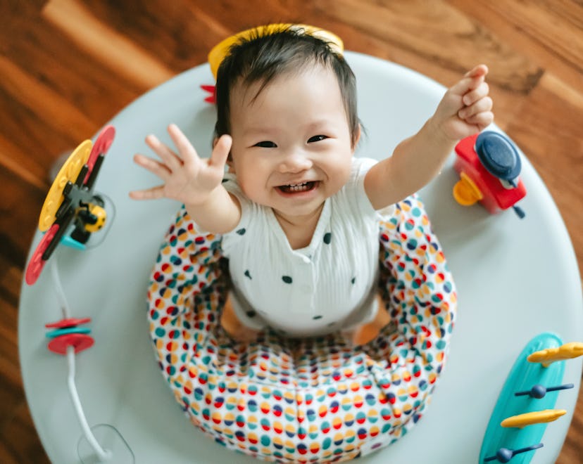 a baby girl having fun playing in activity centre. is it safe to let baby sit in one?