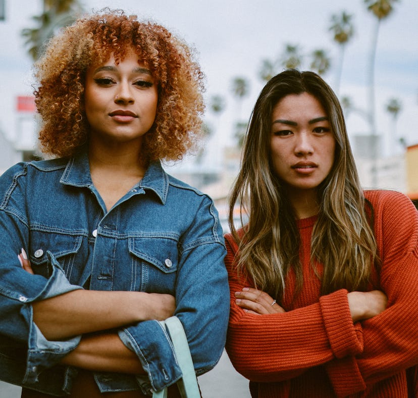 two young women pose for a photo in the street, as they consider why the September 2023 harvest moon...