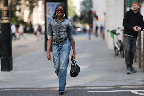 LONDON, ENGLAND - SEPTEMBER 15: Fashion Show Guest was seen wearing black leather heels, a jeans wit...