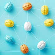 Colorful brain objects connected by dotted lines on blue background. Horizontal composition with cop...