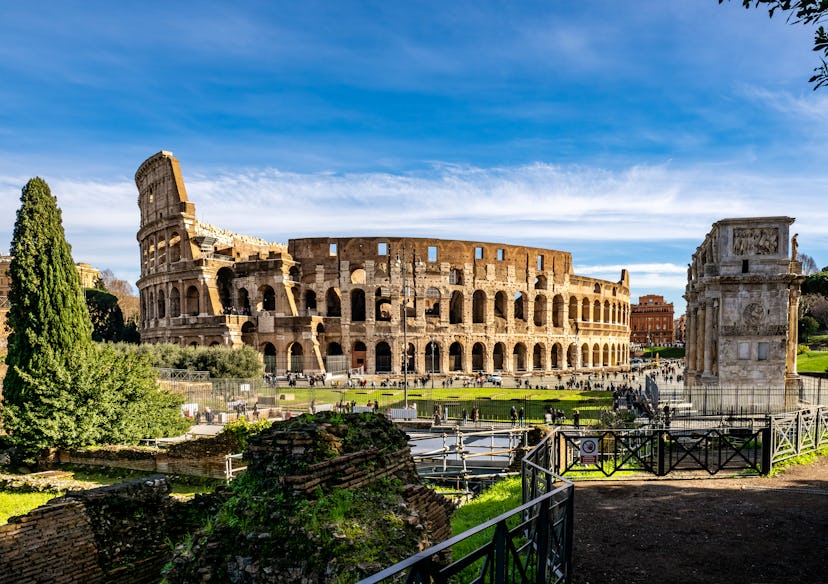 View of the exterior of the Roman Colosseum and Arch of Constantine, it is an amphitheater from the ...