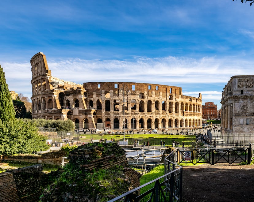 View of the exterior of the Roman Colosseum and Arch of Constantine, it is an amphitheater from the ...