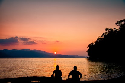 A beautiful Sunset and a couple enjoying the time together at the beach in port Blair, India.