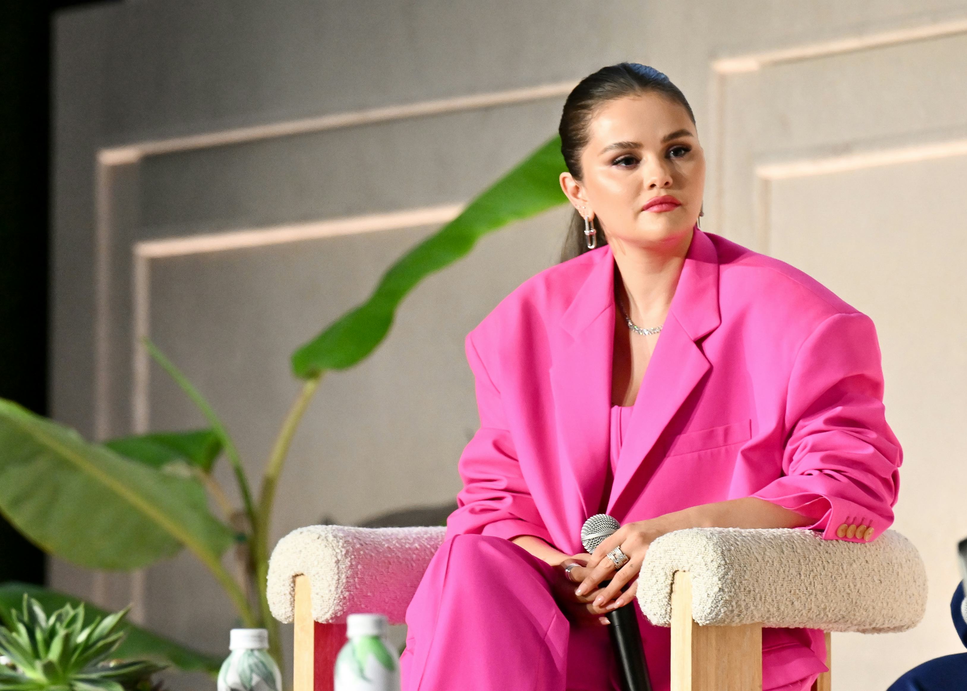 Selena Gomez wore a pink suit, bustier top, and trousers at the Music + Health Summit.