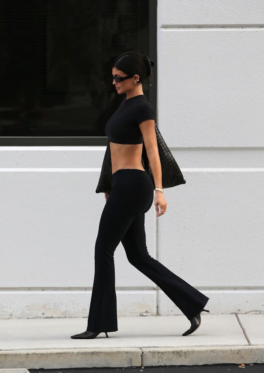 Kylie Jenner wears a tee, yoga pants, sunnies, and a massive bag. 