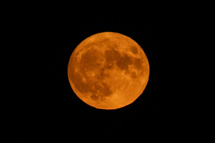 Harvest moon shining behind Rocca Calascio Castle, Abruzzo, Italy on October 1, 2020. During this mo...