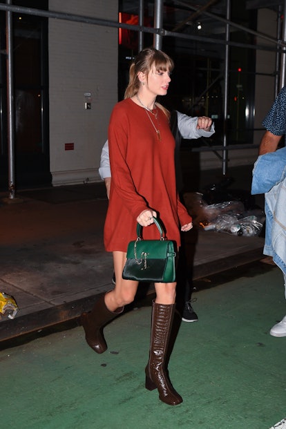 Taylor Swift wears a sweater dress and riding boots in New York City.