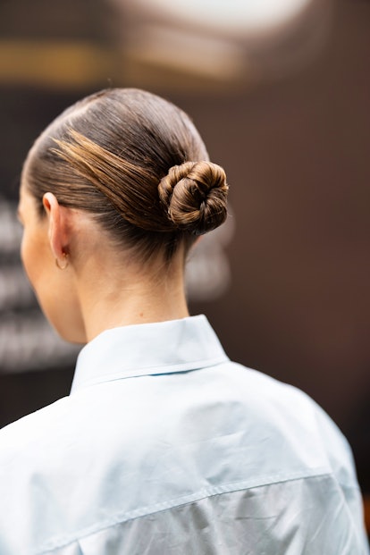 Slicked-back tight buns are a Milan Fashion Week Spring/Summer 2024 street style beauty trend