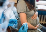 Pregnant woman getting vaccine at home. COVID-19 vaccination concept.