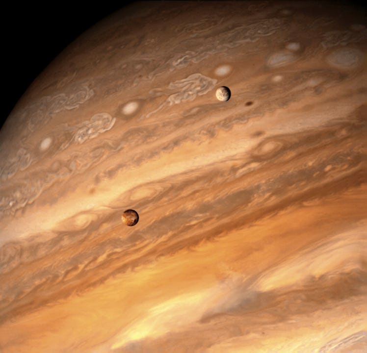 Jupiter's "fire and ice" pairing of large moons, volcanic Io and frozen Europa, in transit over the ...