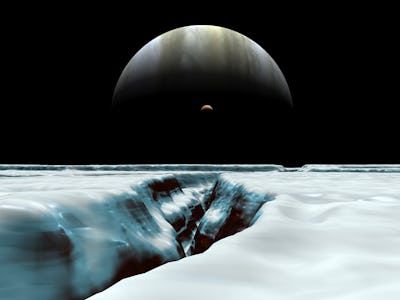 A crescent Jupiter hovers near the horizon along with Jupiter's volcanic satellite Io. In the foregr...