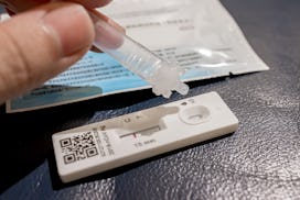 GUANGZHOU, CHINA - DECEMBER 10: A citizen uses a COVID-19 antigen test kit for self-testing on Decem...