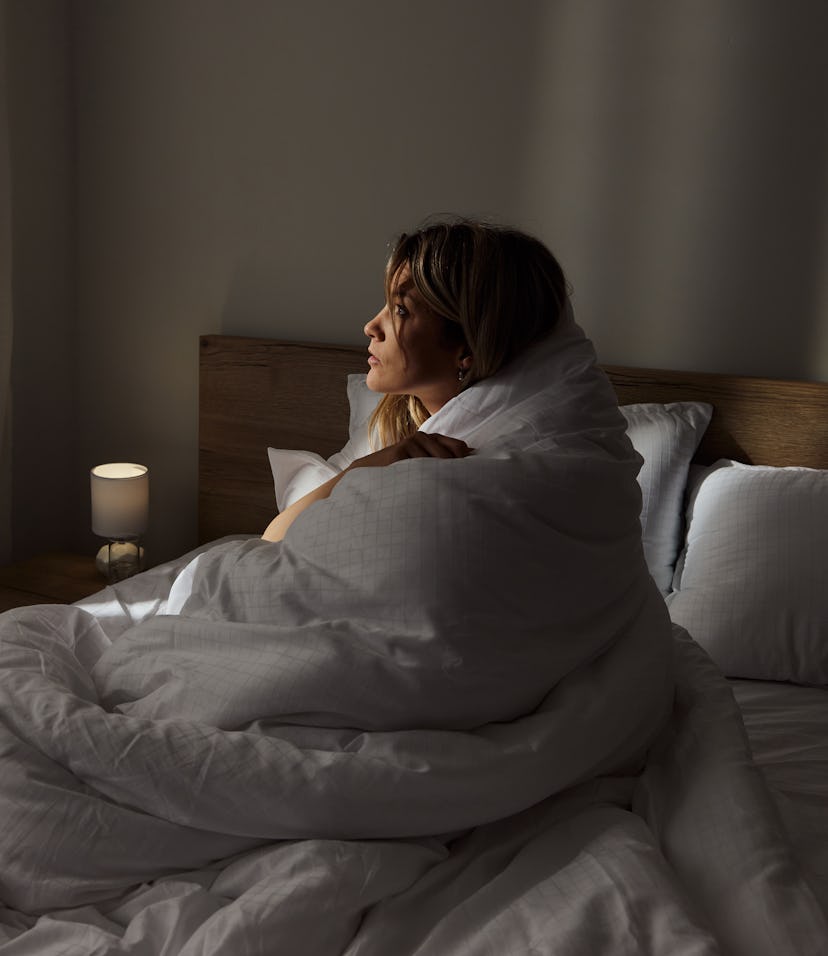 Young woman in bed wonders when is hCG out of your system after miscarriage.