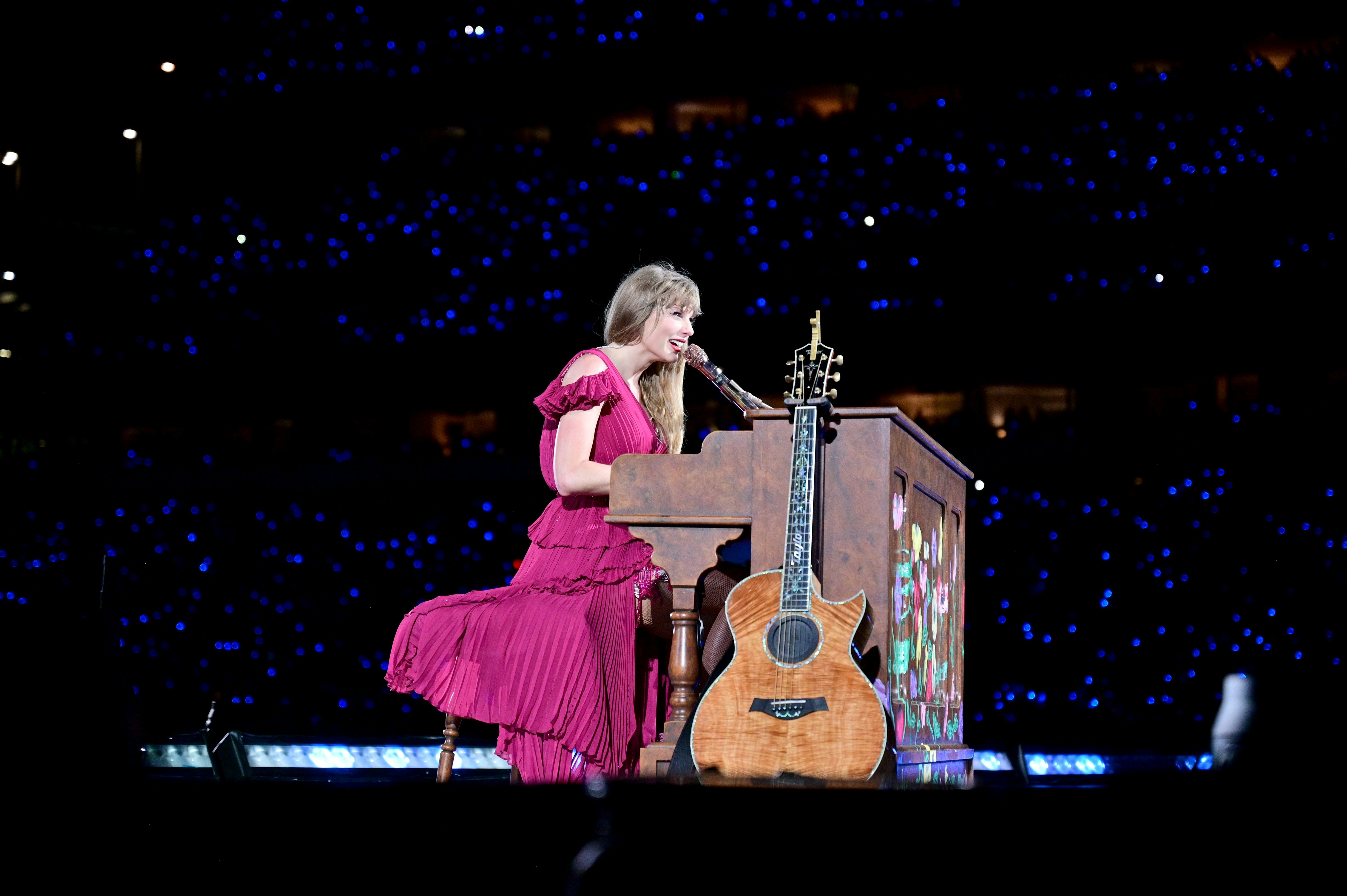 Taylor Swift, a football fan, performs onstage during The Eras tour.