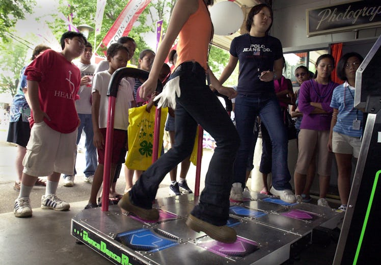 (Left to right) Xee Moua and Pang Moua play the Dance Dance Revolution game in the Penny Arcade near...