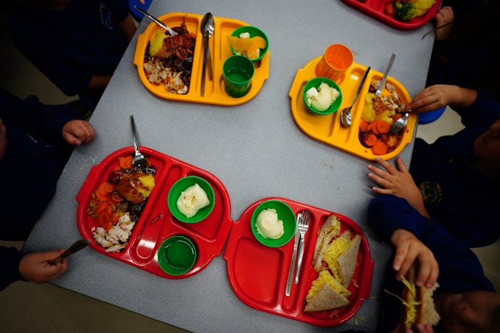 Students eat lunch in the school canteen during the beginning of the roll-out of universal free scho...