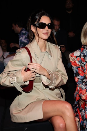 Kendall Jenner wears a trench coat dress to attend the Gucci show at Milan Fashion Week. 