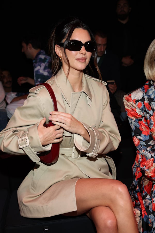 Kendall Jenner wears a trench coat dress to attend the Gucci show at Milan Fashion Week.