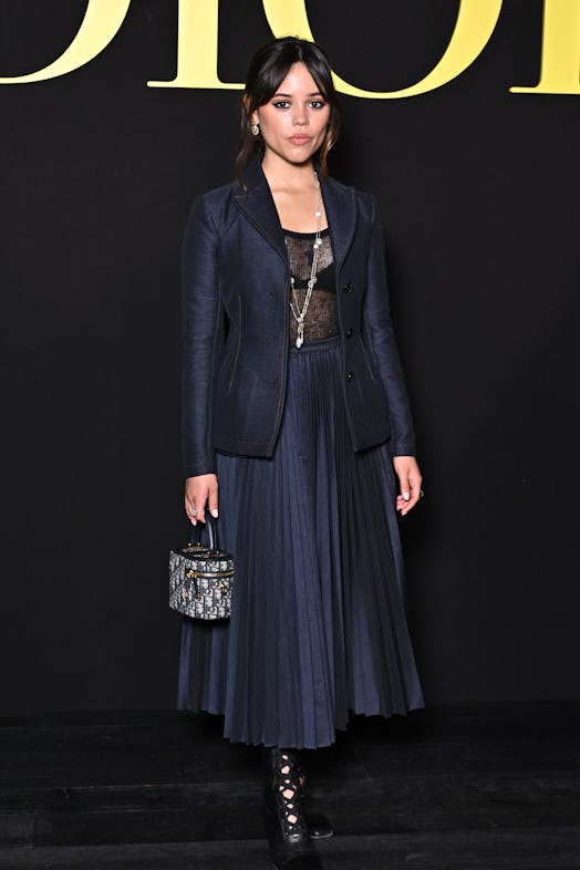 Jenna Ortega wears a denim skirt suit set from Christian Dior to attend Paris Fashion Week.
