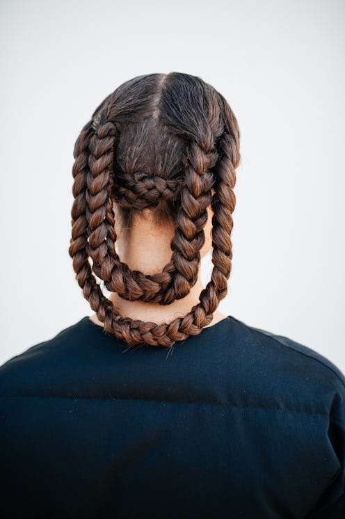 Braided ponytails are a Paris Fashion Week Spring/Summer 2024 street style beauty trend