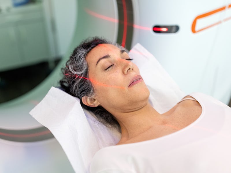 Close-up of hispanic female patient getting an MRI scan. Woman having CT scan test in the hospital.