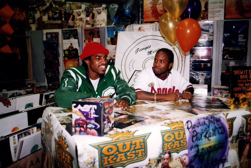 Rappers André 3000 (André Benjamin) and Big Boi (Antwan Patton) of Outkast signs autographs and gree...