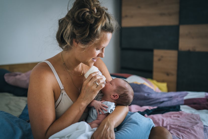 mother bottle feeding newborn in article about whether you need a bottle sterilizer