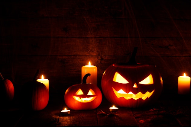 Halloween pumpkins with cut faces and candles in article about religions that don't celebrate hallow...
