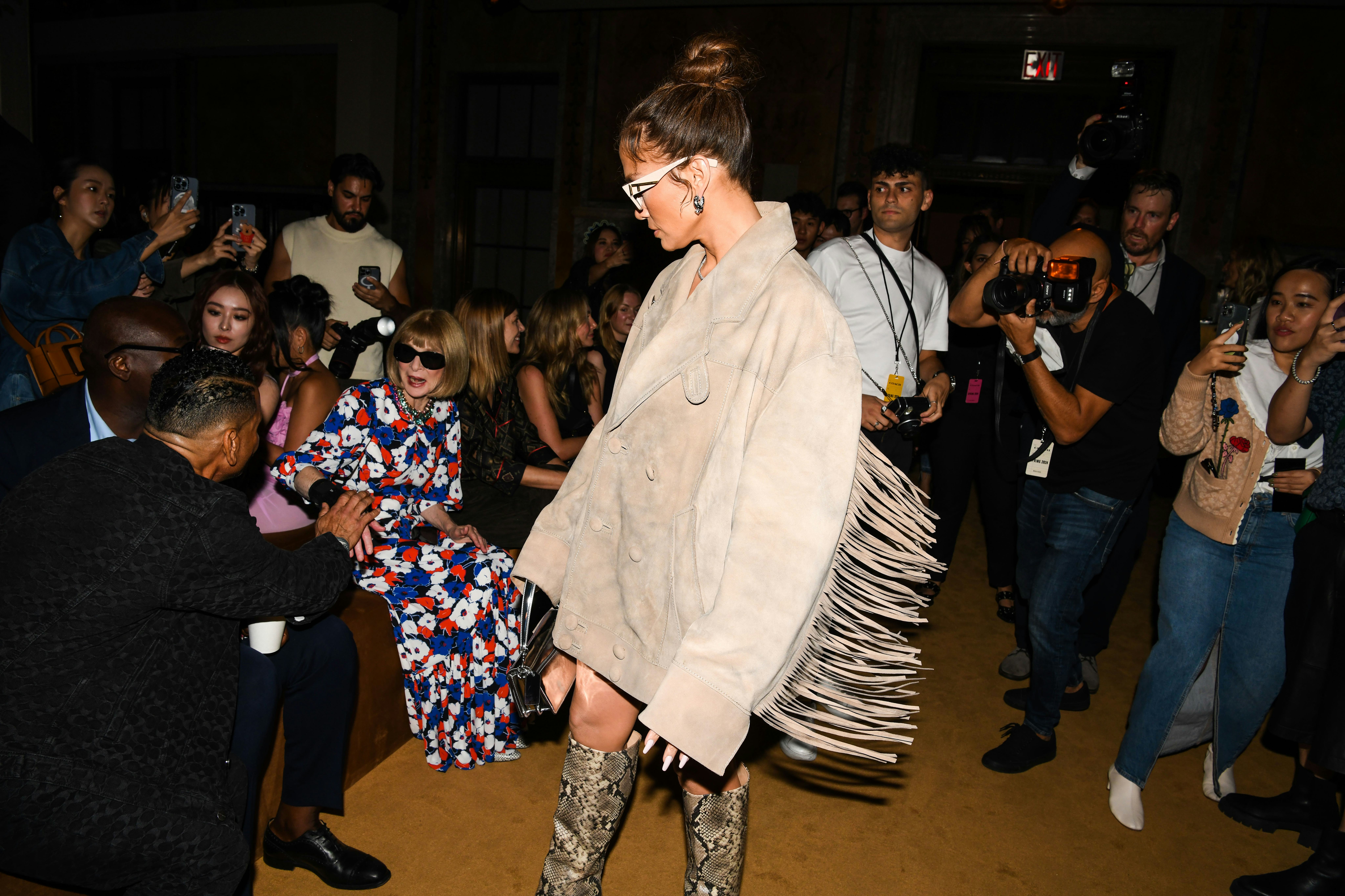 Jennifer Lopez wears a suede jacket, snakeskin boots, and a Coach Tabby bag at the COACH Spring 2024&hellip;