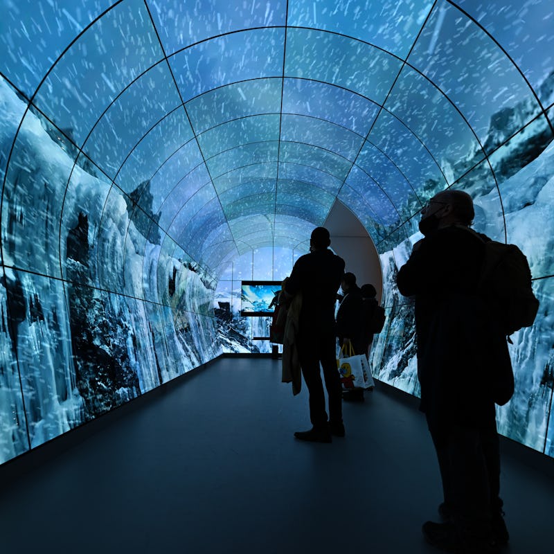 LAS VEGAS, NEVADA - JANUARY 10: Visitors get experience into the LG's immersive screen tunnel at CES...