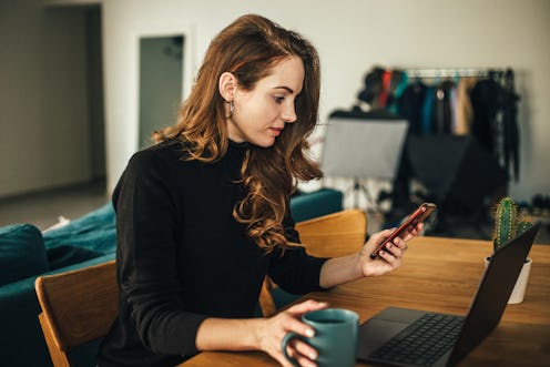 Young happy woman using laptop at home