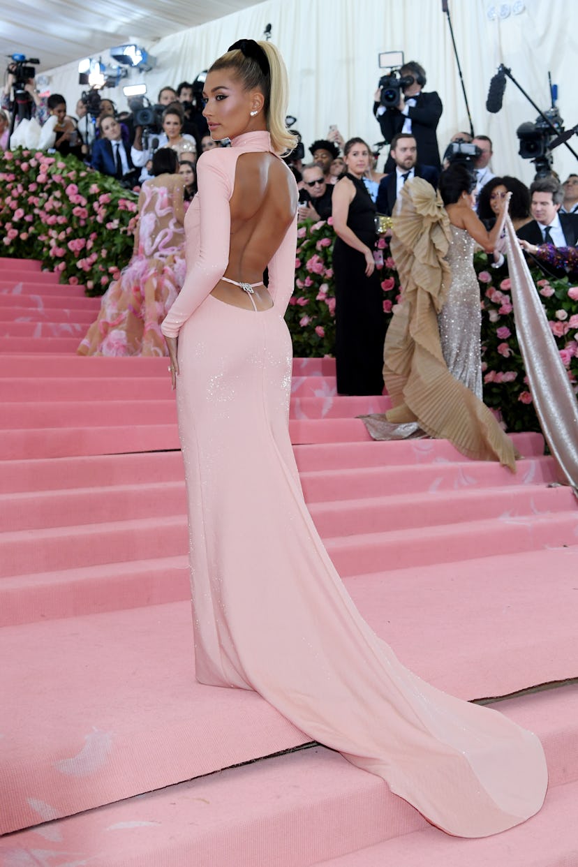 Hailey Bieber wears a pink whale tail gown to the 2019 Met Gala Celebrating Camp: Notes on Fashion.