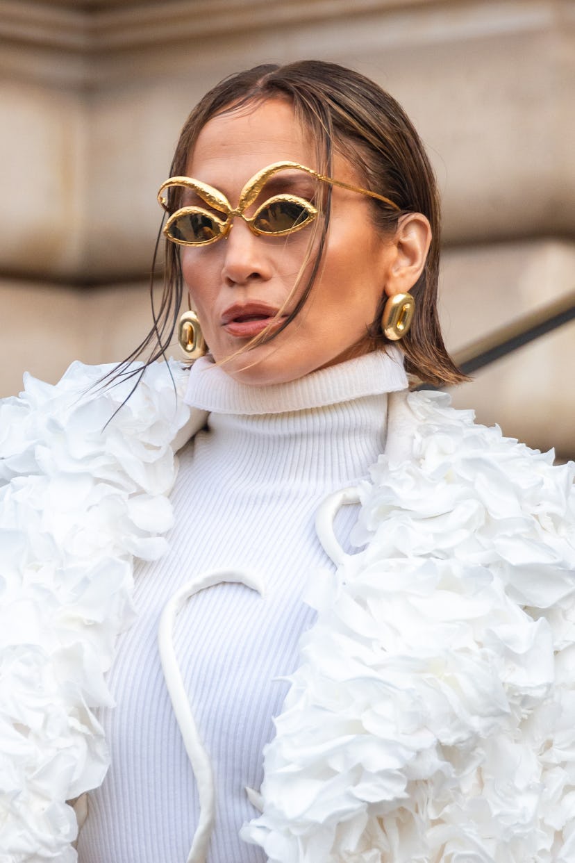 Jennifer Lopez attends the Schiaparelli Haute Couture Spring/Summer 2024 show in Paris in a white co…