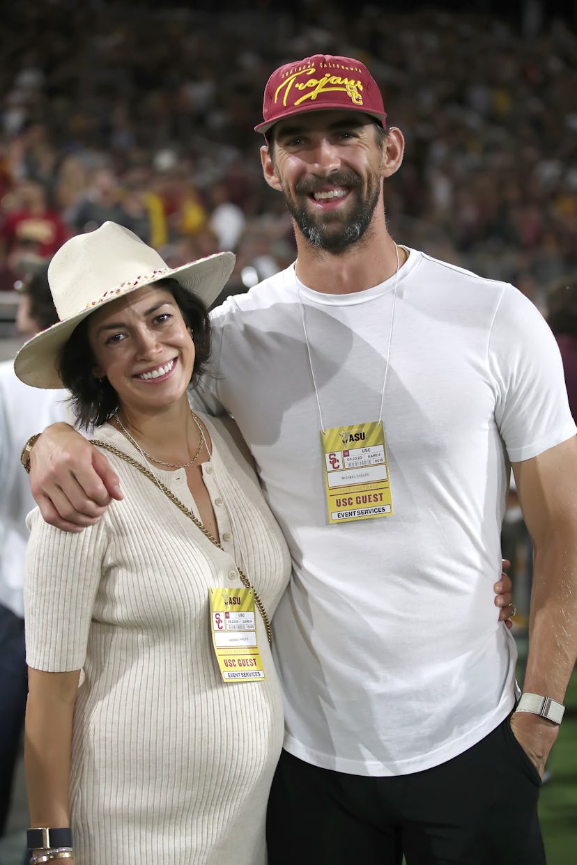 TEMPE, ARIZONA - SEPTEMBER 23: Michael Phelps and his wife Nicole Phelps, an USC graduate, pose for ...