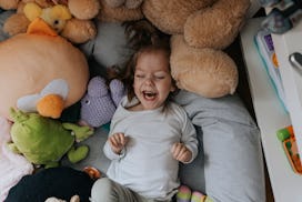 Happy disabled girl lying on bed