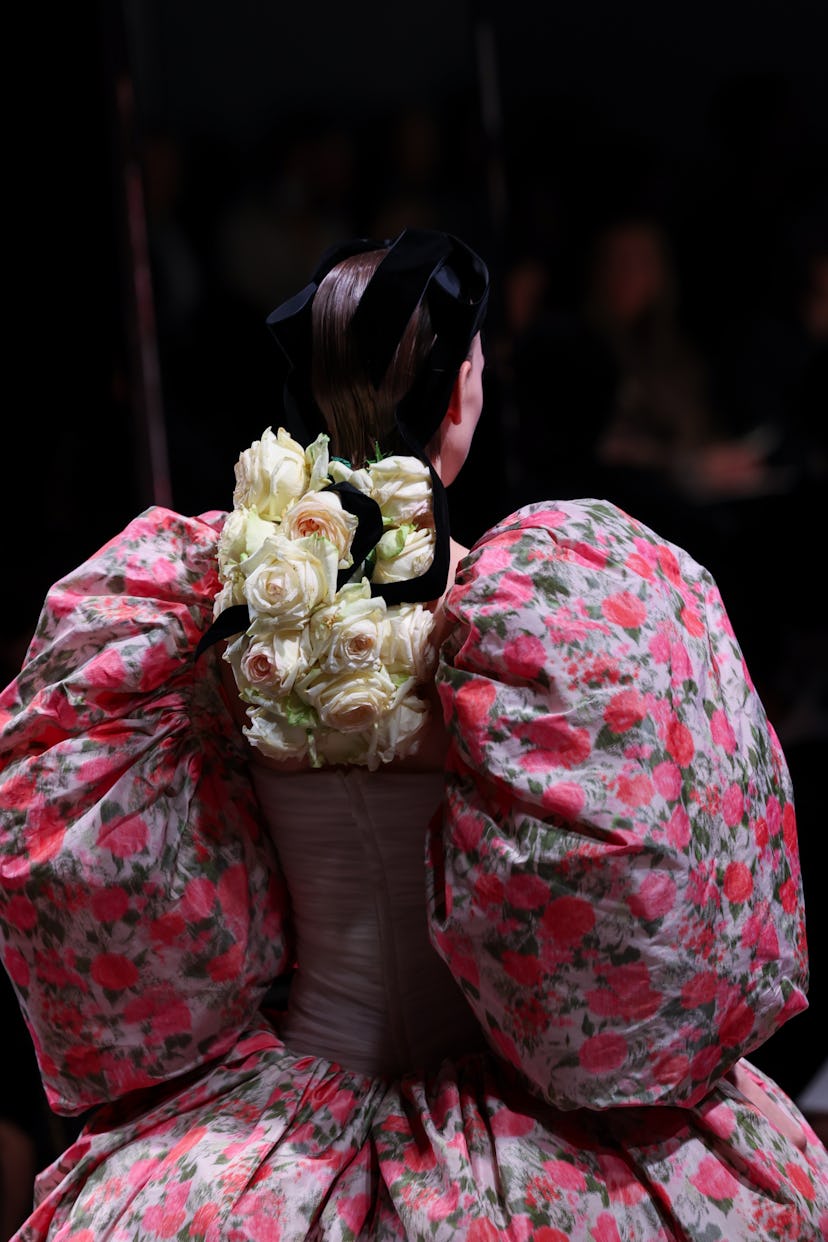 A model walks the runway with rose braids during the Giambattista Valli Haute Couture Spring/Summer ...