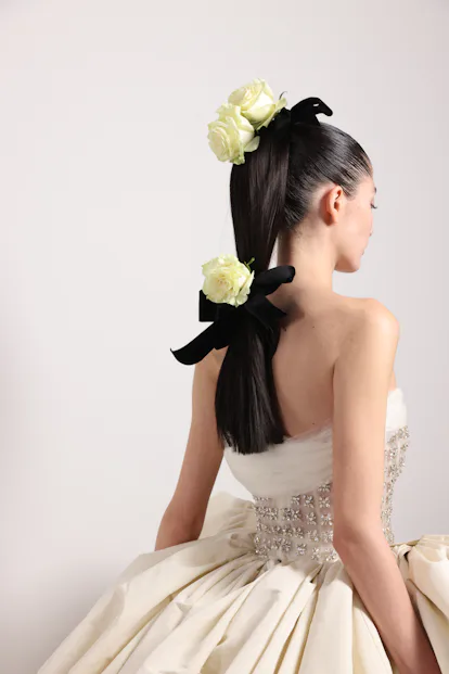 The Giambattista Valli couture show featured hairstyles with real roses wrapped in ribbons.