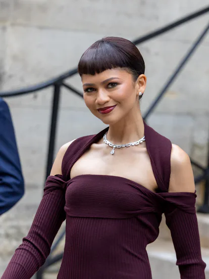 At the Fendi Haute Couture show, Zendaya sported micro bangs and burgundy lip color.