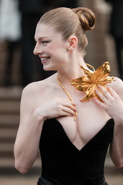 Hunter Schaefer styled her hair in a structured slicked back bun at the Schiaparelli haute couture show.